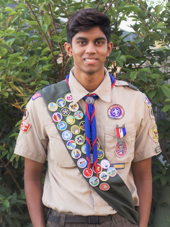 Mahit Vunnam pictured in a tan Eagle Scout uniform displaying an olive colored sash with a variety of patches