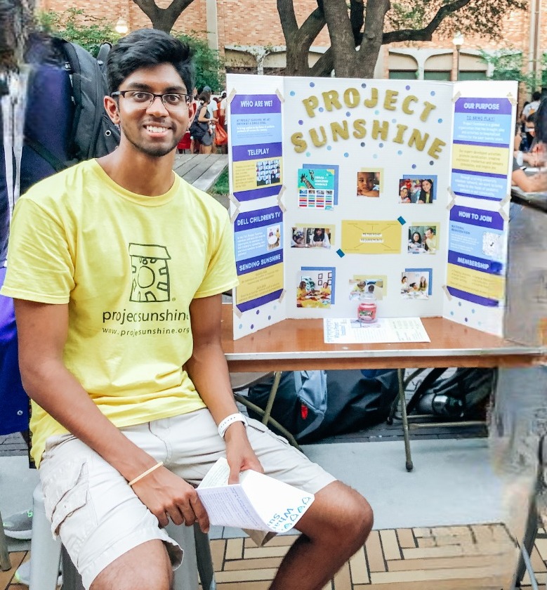 Mahit Vunnam sitting next to his science fair project